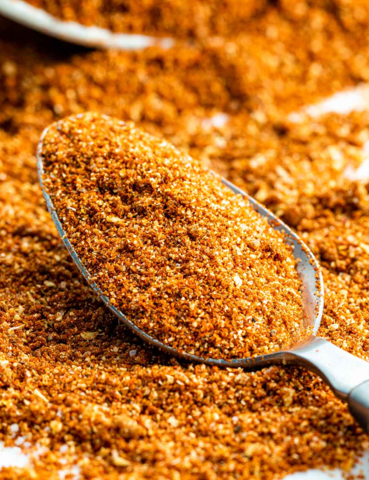 closeup sideview shot of a tablespoon with bbq dry rub surround by it