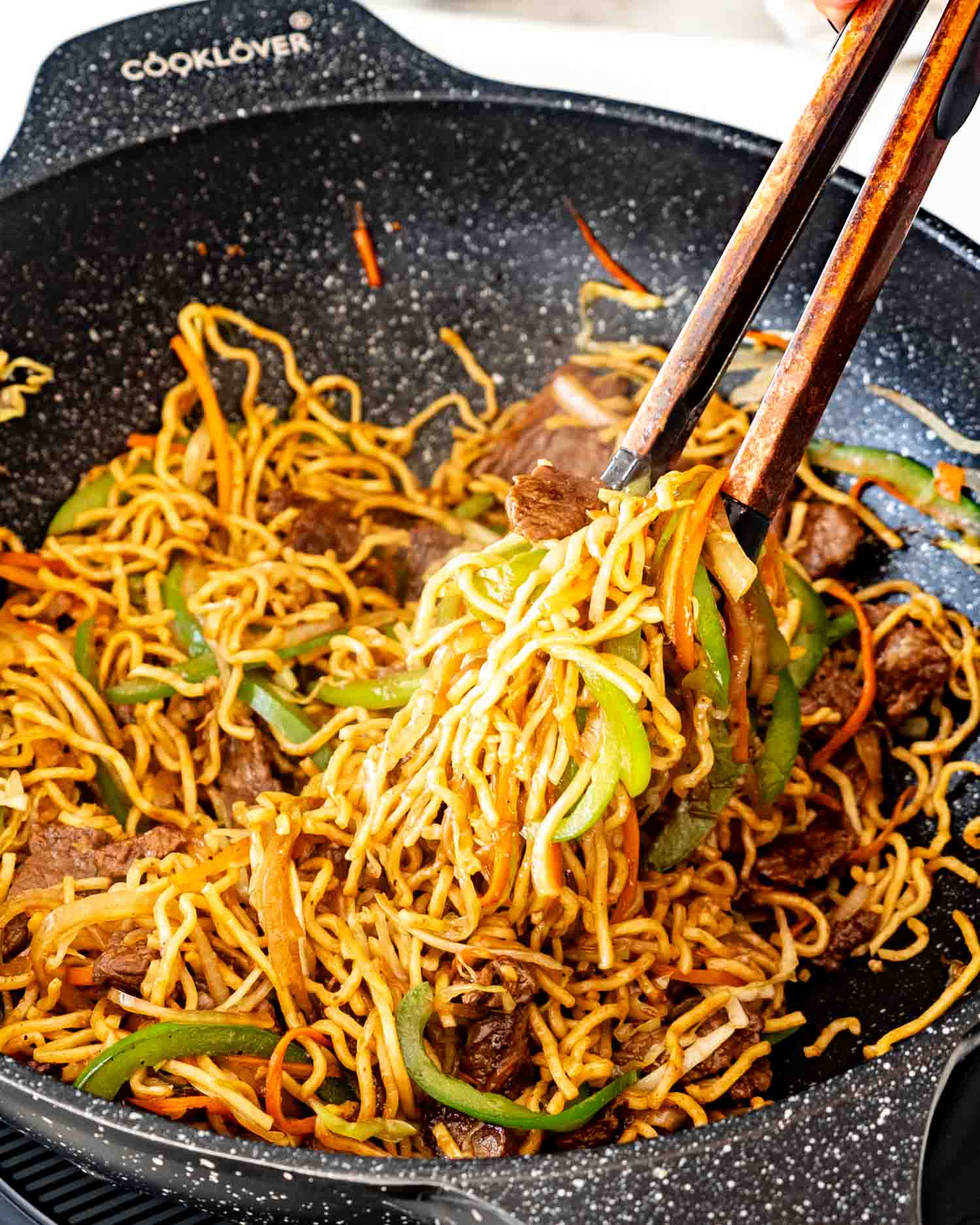 freshly made beef chow mein in a wok.