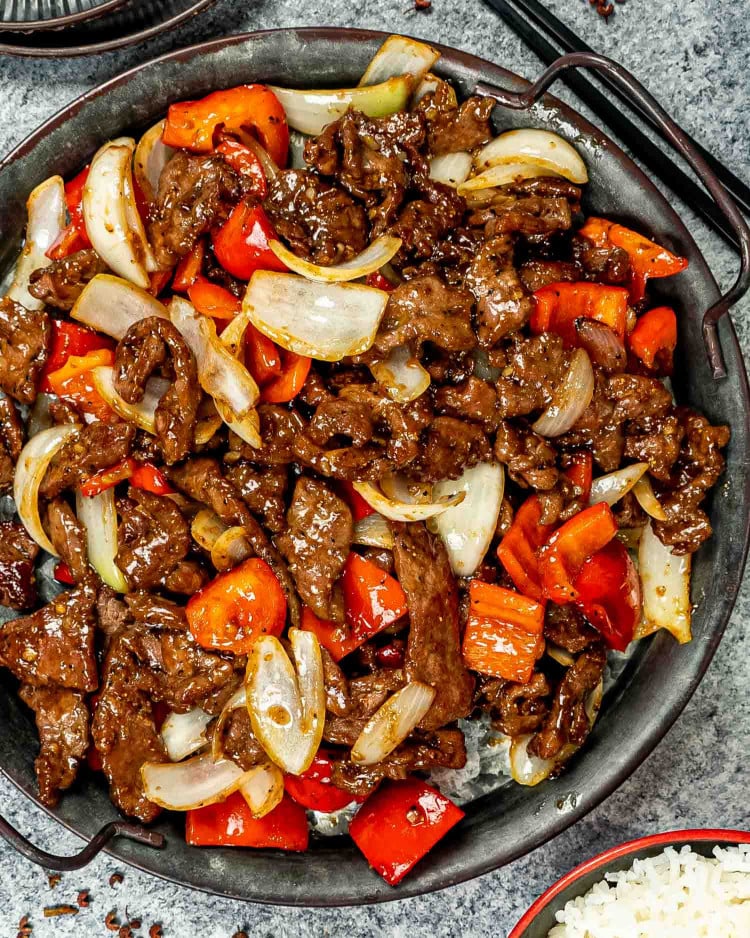 black pepper beef in a metal serving plate.