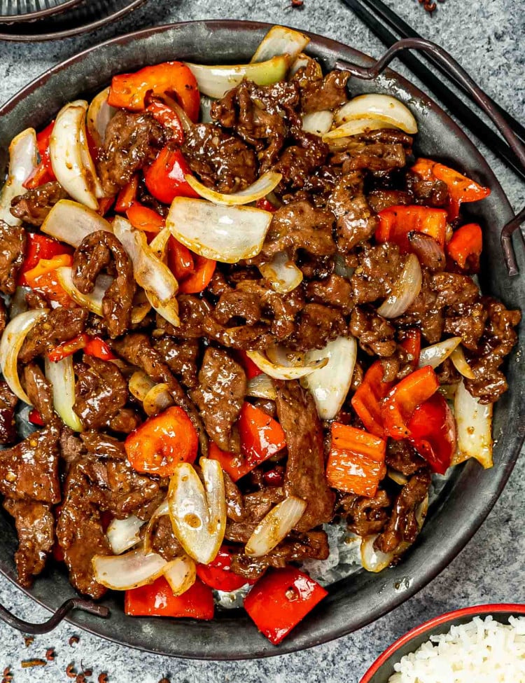 black pepper beef in a metal serving plate.