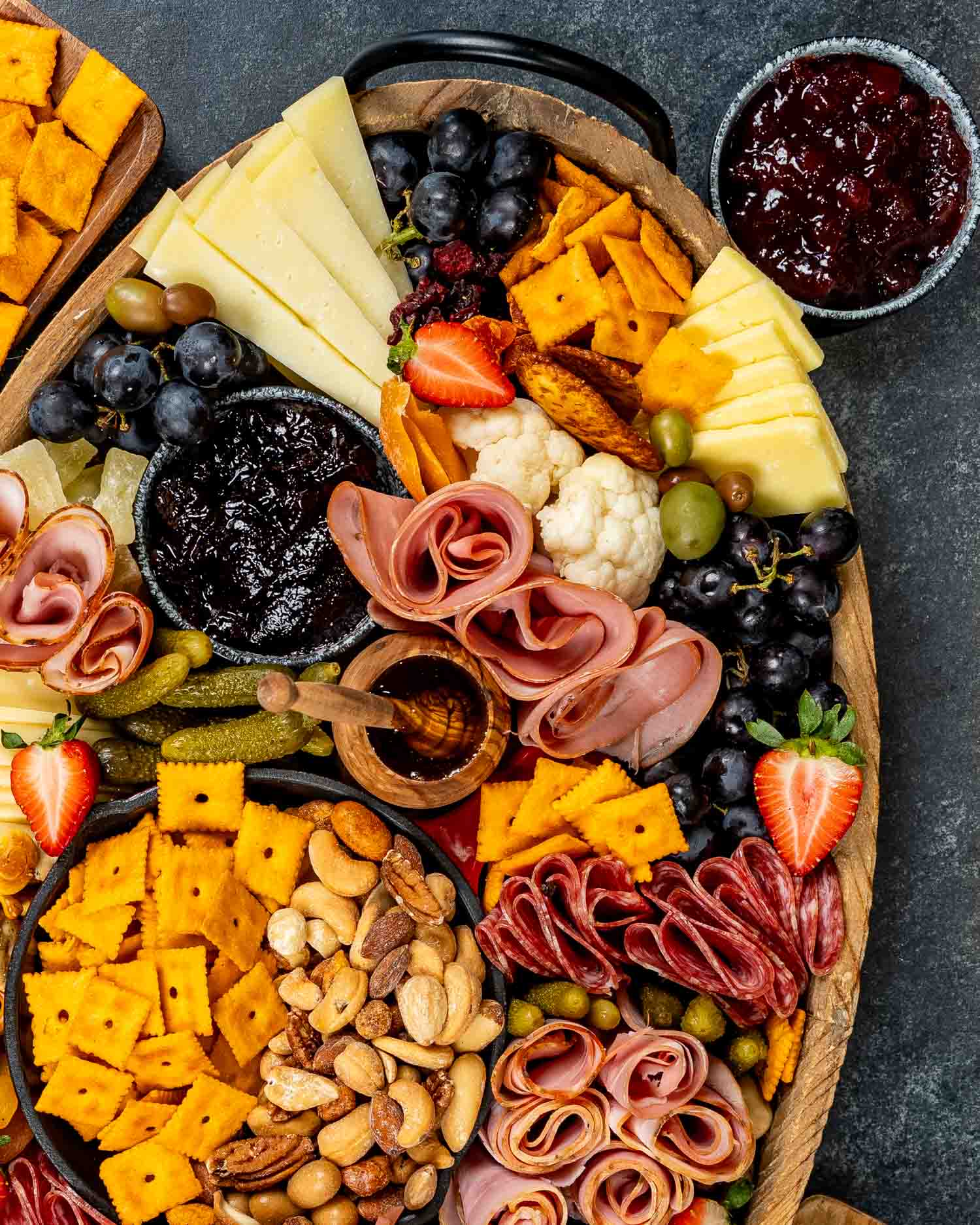 a gorgeous charcuterie board loaded with cured meats, pickled vegetables, an assortment of cheeses and crackers.