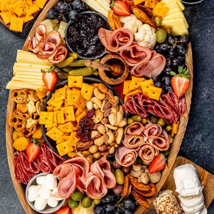 a gorgeous charcuterie board loaded with cured meats, pickled vegetables, an assortment of cheeses and crackers.