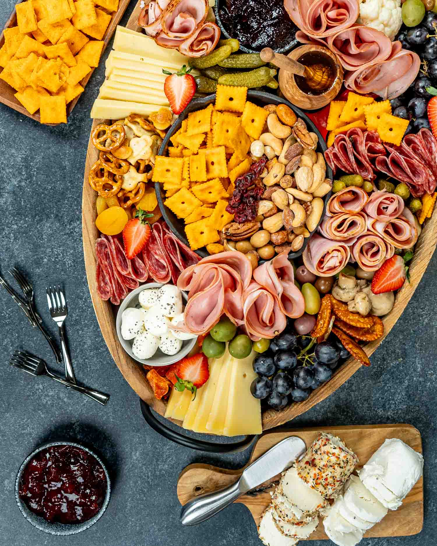 a gorgeous charcuterie board loaded with cured meats, pickled vegetables, an assortment of cheeses and crackers.