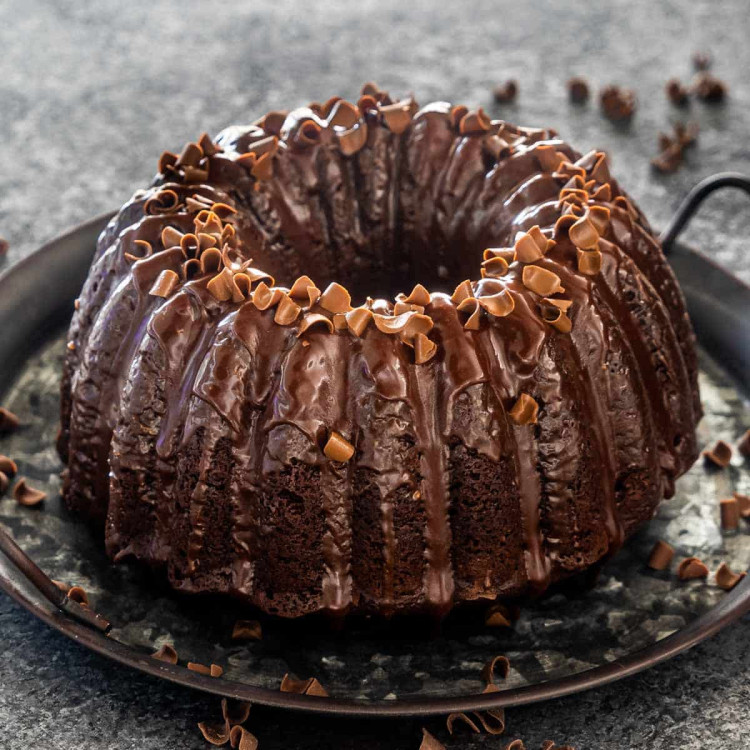 chocolate bundt cake topped with chocolate ganache and sprinkled with chocolate shavings.