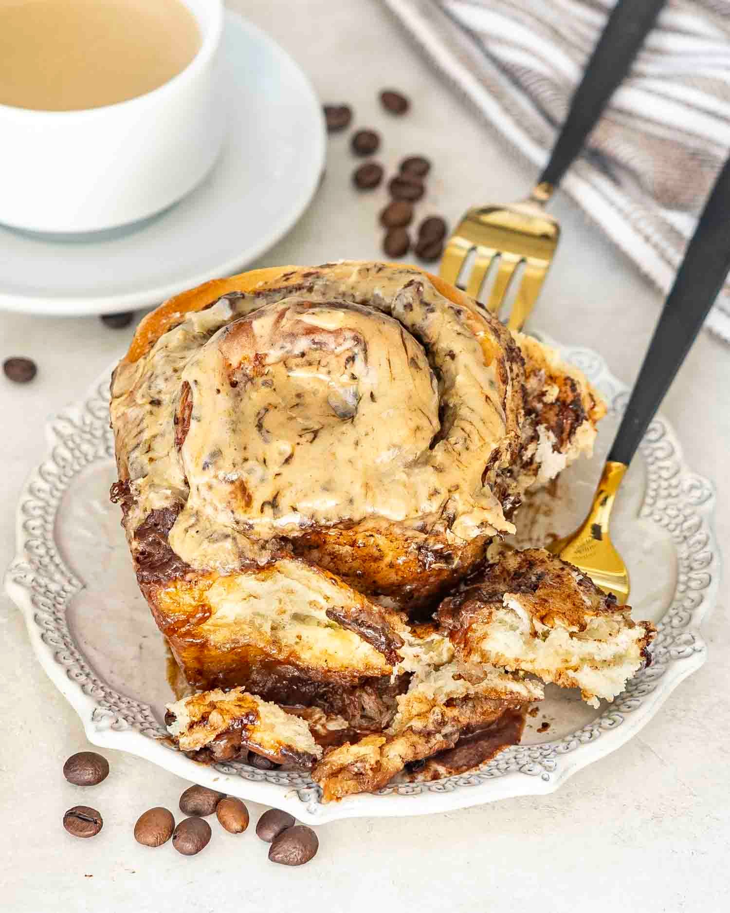 an ultra gooey chocolate espresso roll on a dessert plate.