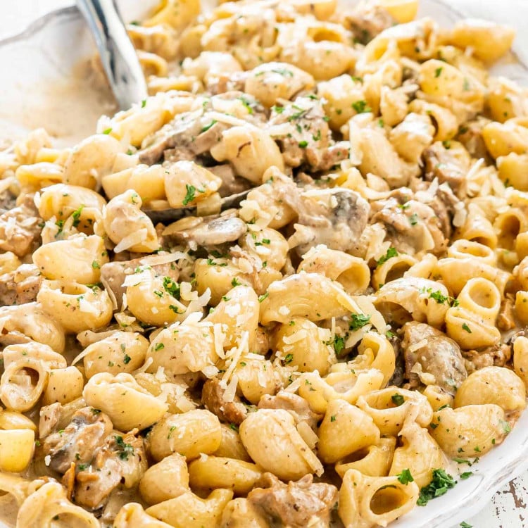 creamy chicken marsala pasta in a white platter.