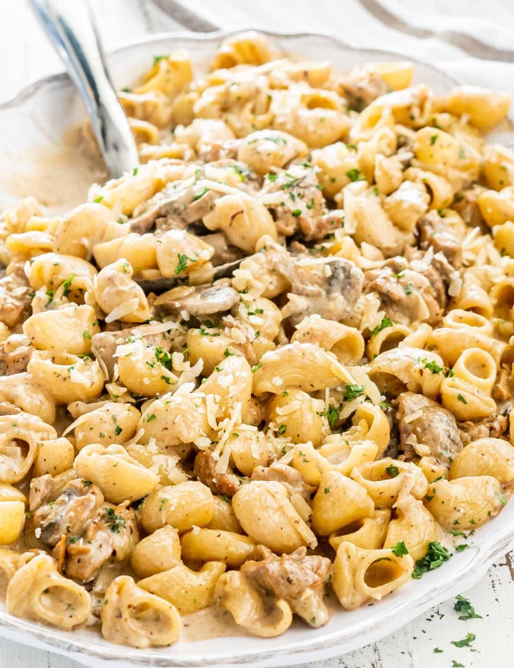 creamy chicken marsala pasta in a white platter.