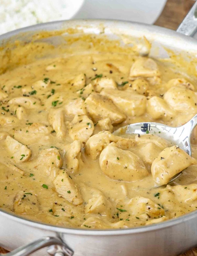 Creamy Ranch Chicken and Gravy in a skillet garnished with parsley.