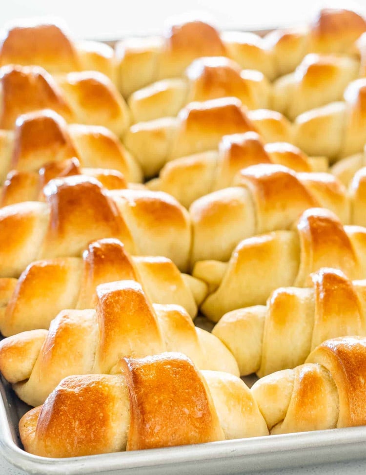 freshly baked crescent rolls on a baking sheet.