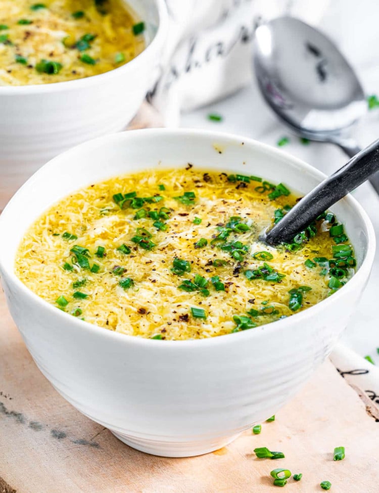 a bowl of egg drop soup with a spoon in it