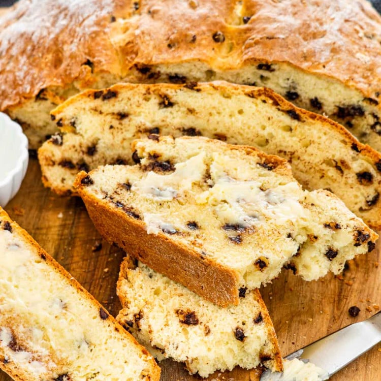 irish soda bread with chocolate chips on a cutting board with a few slices.