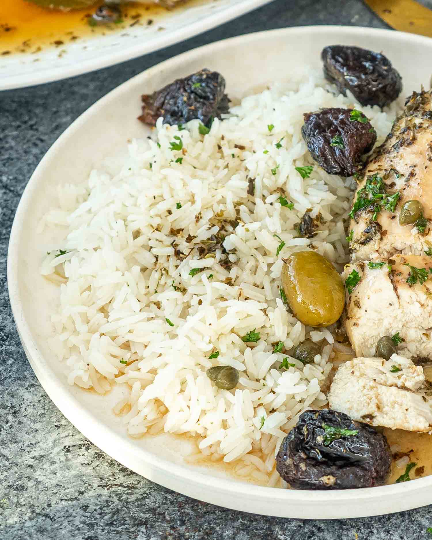 a plate full of chicken marbella with jasmin erice.