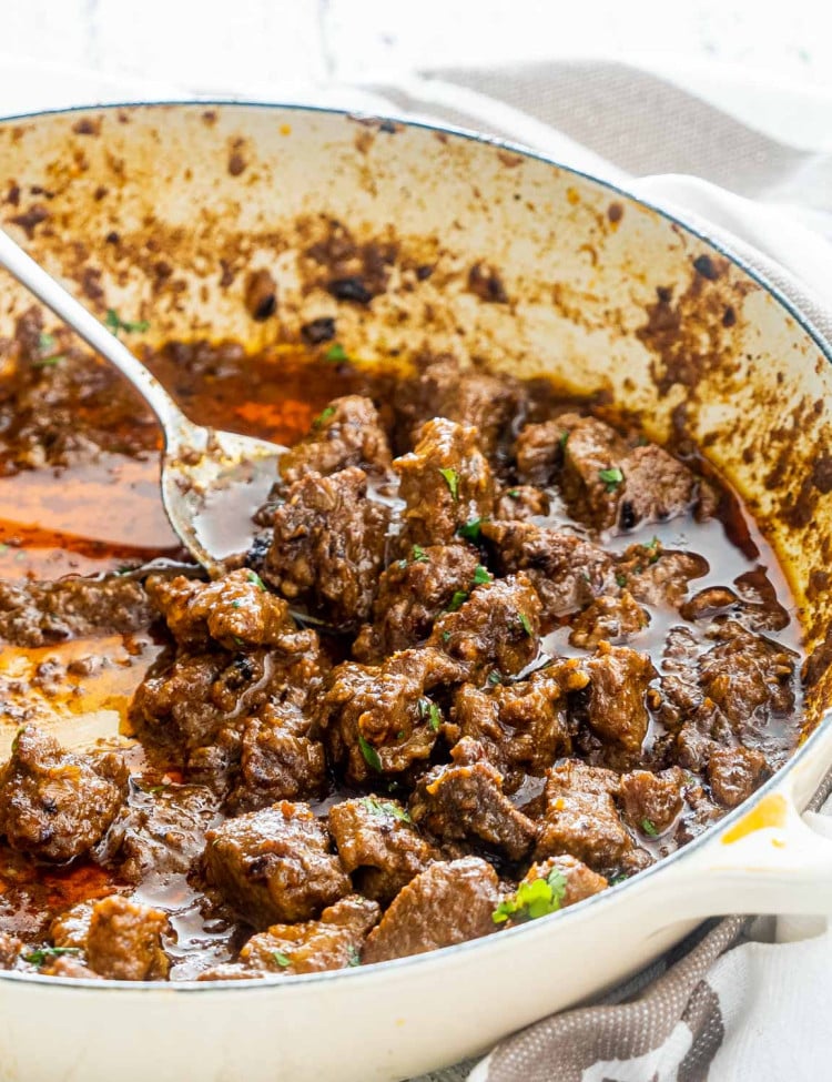 freshly made lamb korma in a beige braiser.