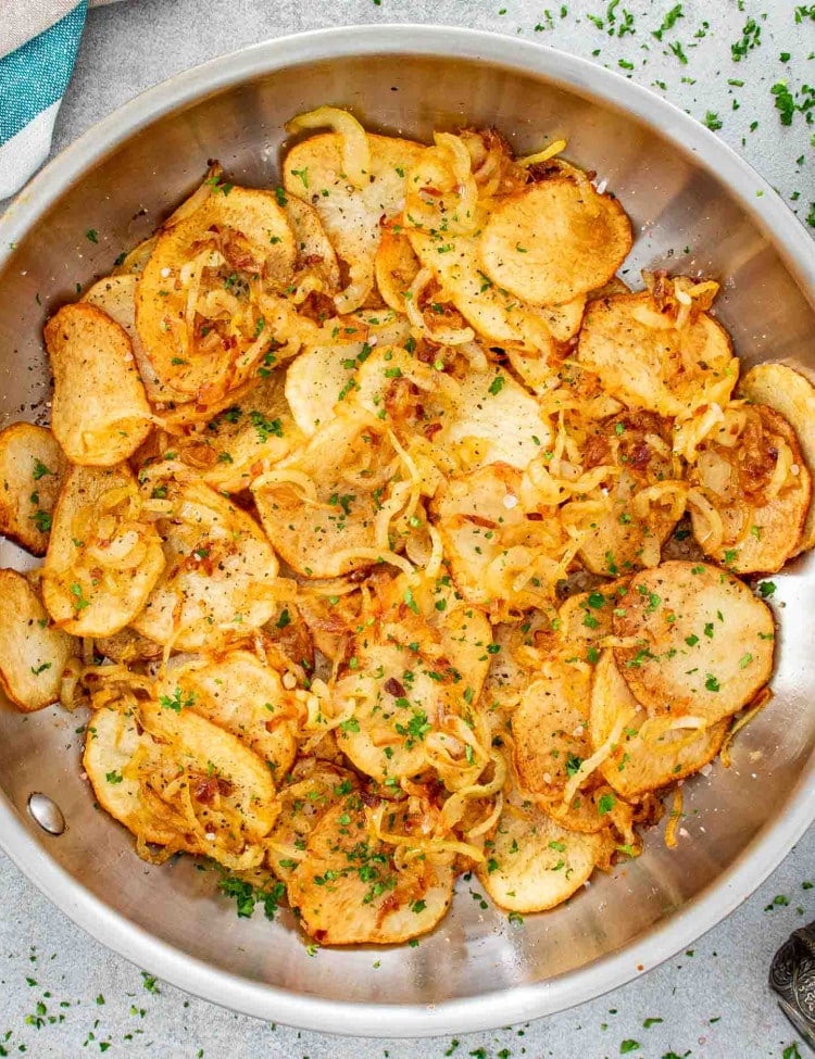 lyonnaise potatoes in a stainless steel skillet.