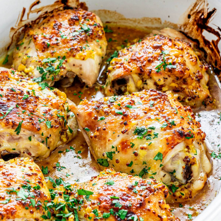 side view shot of oven baked chicken thighs in a pan