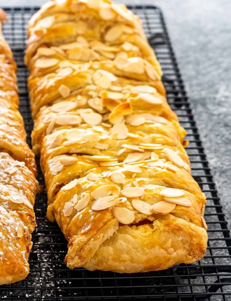 two peach strudels on a cooling rack.