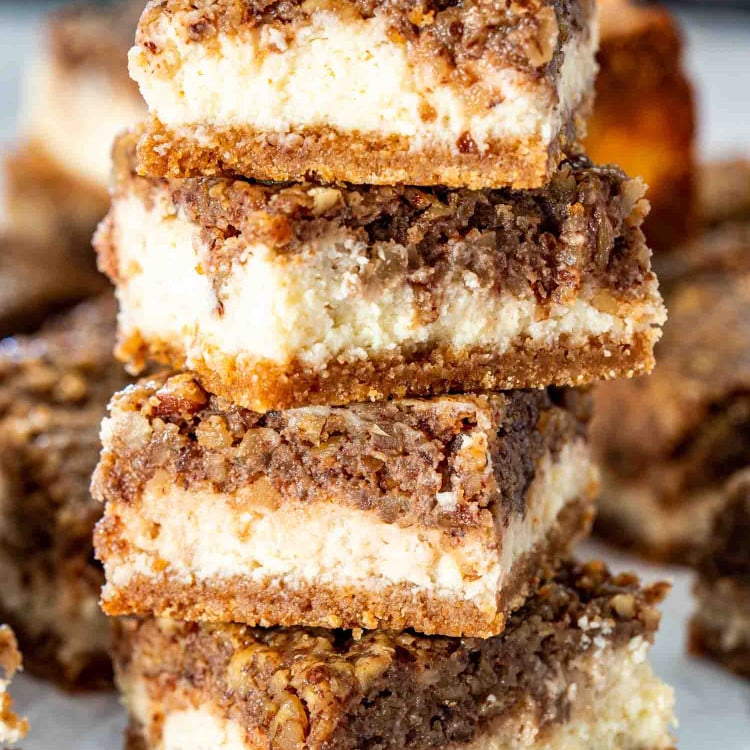 stacked pecan pie cheesecake bars.