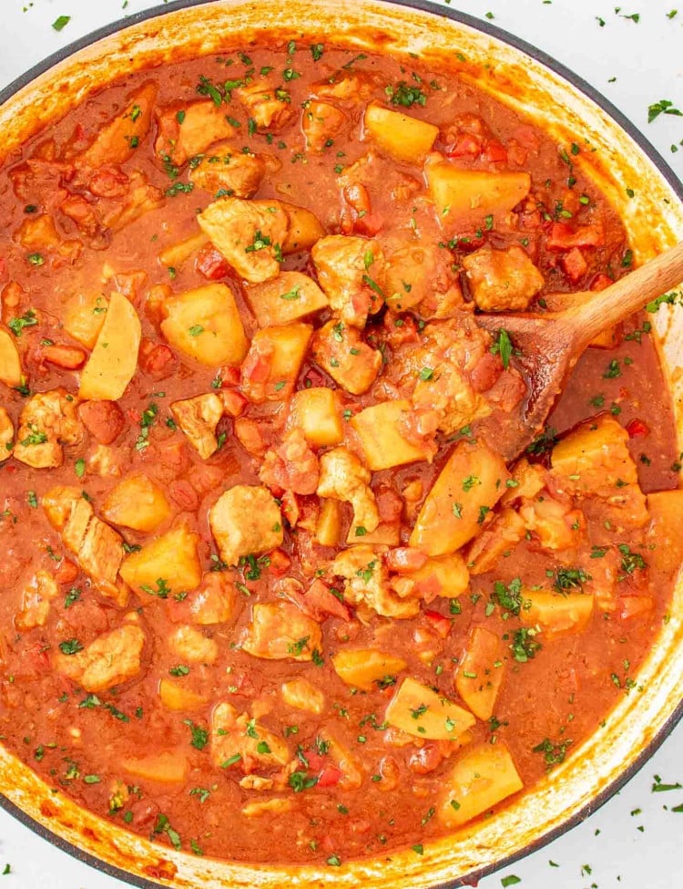 freshly made pork and potatoes in a skillet.