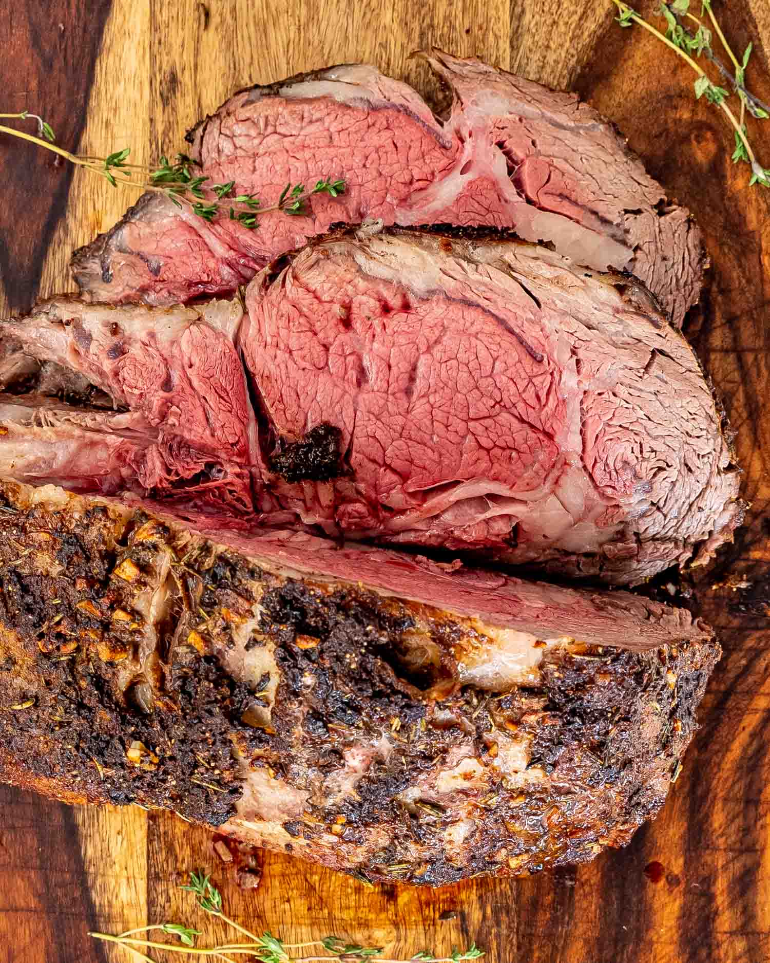 a sliced prime rib roast on a cutting board.