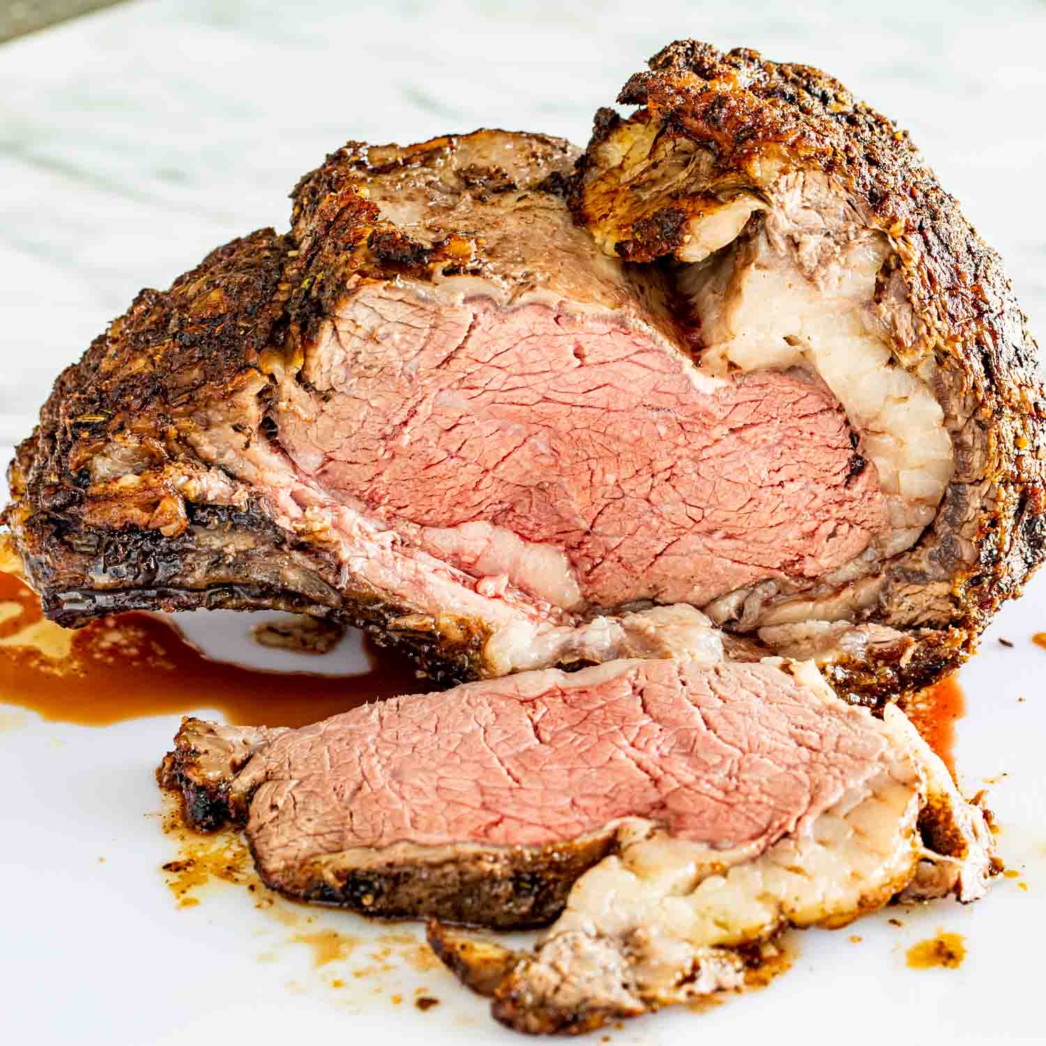 a sliced prime rib roast on a cutting board.