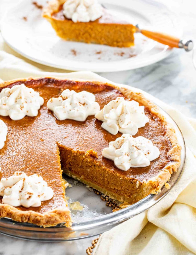 a freshly baked pumpkin pie with whipped cream.