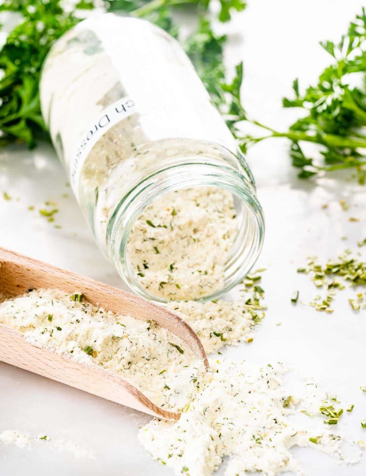 a jar with homemade ranch dressing mix and a scoop.