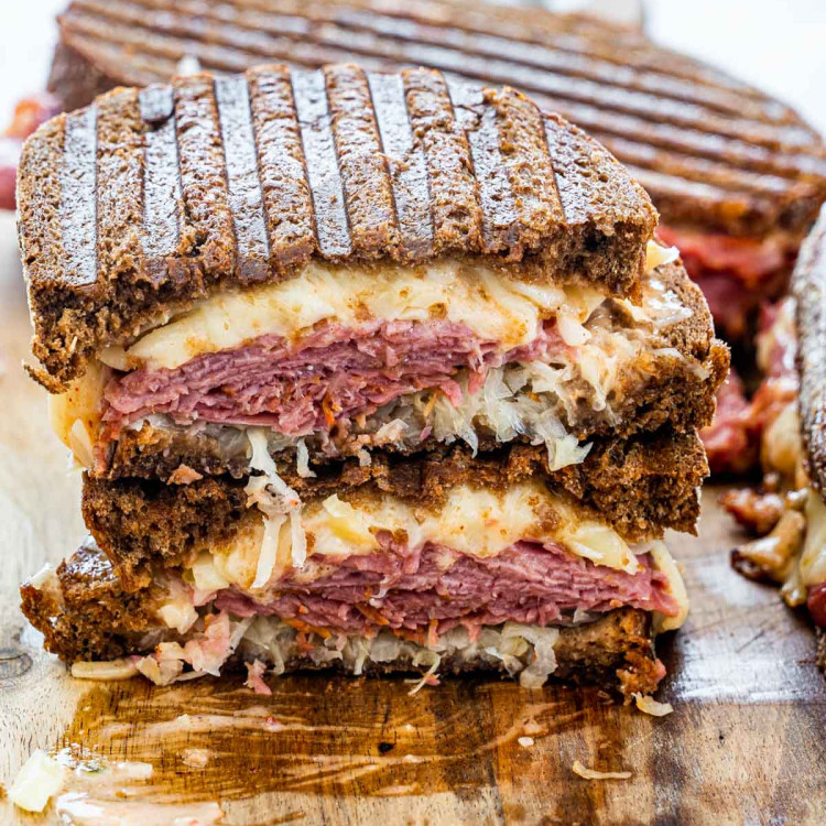 A reuben sandwich cut in half and stacked with the centers exposed