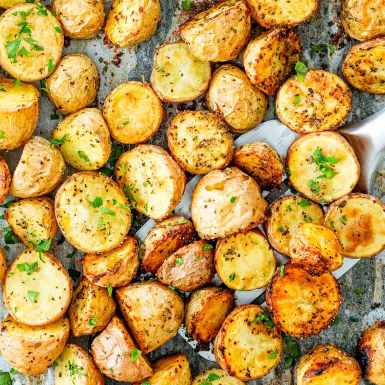 overhead shot of roasted baby potatoes on a baking sheet.