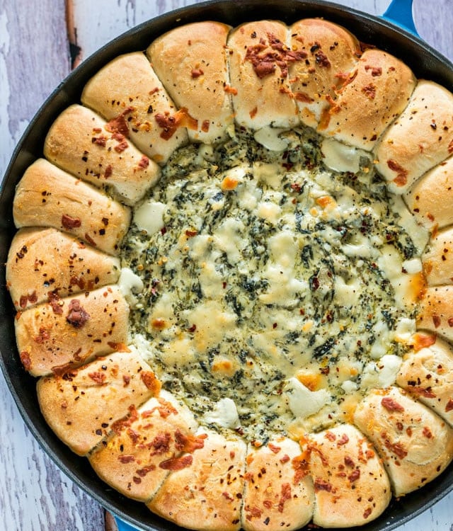 overhead shot of skillet pull apart bread with spinach and artichoke dip