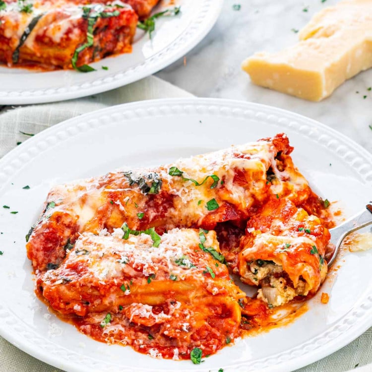 side view shot of stuffed manicotti on a plate