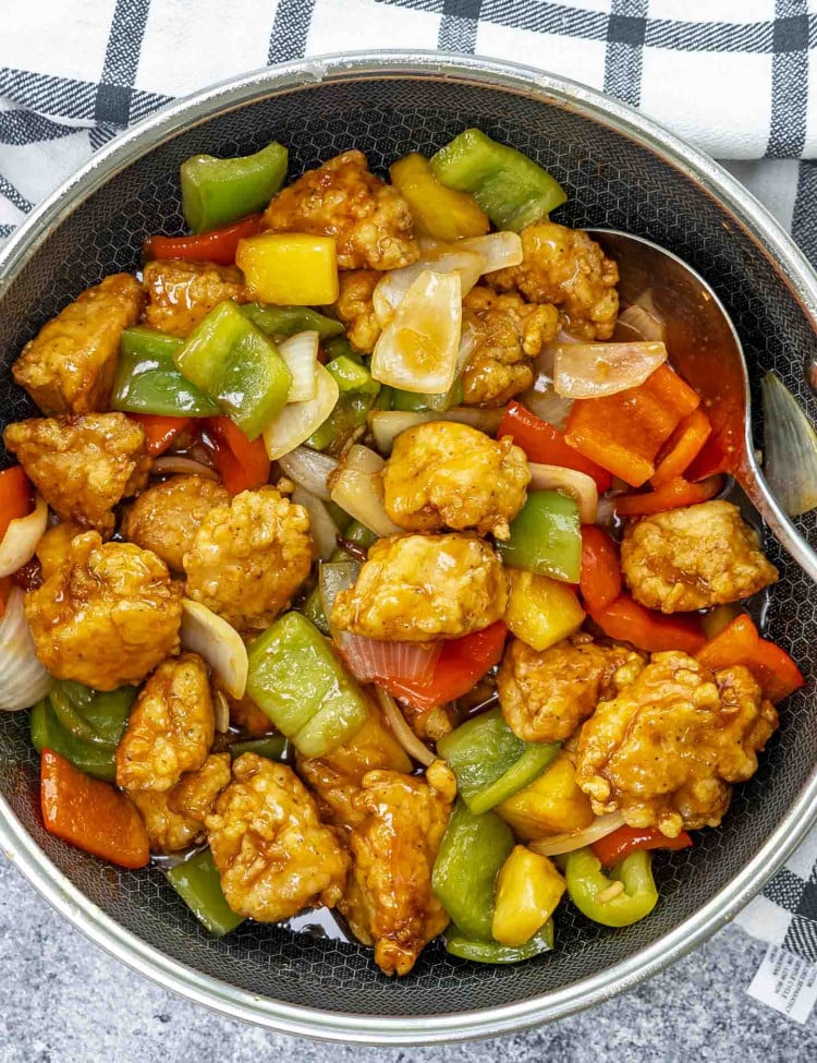 freshly made sweet and sour chicken in a wok.