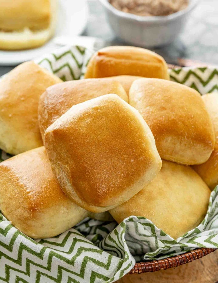 side view shot of a basket full of texas roadhouse rolls.